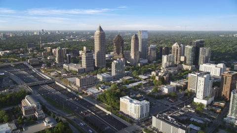 AX39_030.0000141F - Aerial stock photo of The I-85 freeway and Midtown Atlanta skyscrapers in Georgia