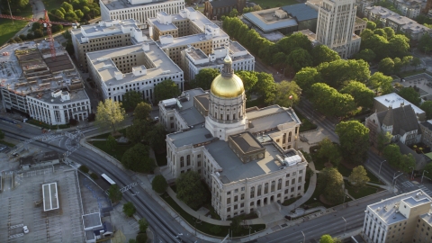 AX39_040.0000072F - Aerial stock photo of Georgia State Capitol and its gold dome, Downtown Atlanta, sunset