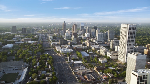 AX39_049.0000319F - Aerial stock photo of Downtown Connector along city buildings; Midtown Atlanta, Georgia