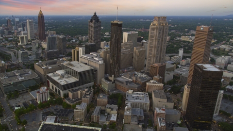 AX40_004.0000430F - Aerial stock photo of Westin Peachtree Plaza Hotel and skyscrapers in Downtown Atlanta, Georgia, twilight