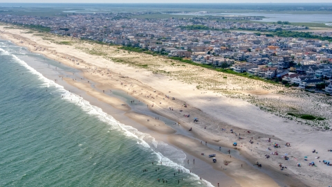 AXP071_000_0024F - Aerial stock photo of People on the beach and beachfront homes in Ocean City, New Jersey