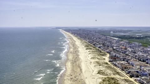 AXP071_000_0025F - Aerial stock photo of Beach goers and beachfront neighborhoods in Ocean City, New Jersey