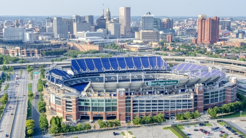 AXP073_000_0021F - Aerial stock photo of M&T Bank Stadium with Downtown Baltimore skyscrapers in the background, Maryland