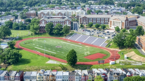 AXP075_000_0014F - Aerial stock photo of McKinley Technology High School and football field in Washington DC