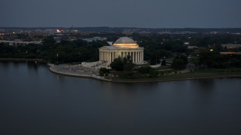 AXP076_000_0034F - Aerial stock photo of The Jefferson Memorial lit up for evening, Washington, D.C., twilight