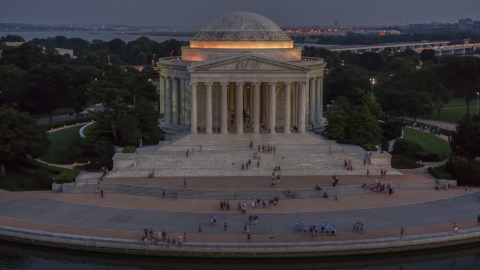 AXP076_000_0037F - Aerial stock photo of Visitors at the Jefferson Memorial, lit up at twilight in Washington, D.C.