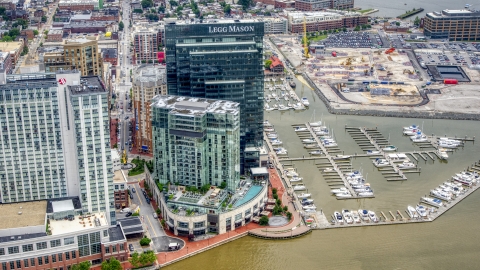 AXP078_000_0007F - Aerial stock photo of Marriott and Four Seasons hotels, Legg Mason Tower, and Harbor East Marina in Baltimore, Maryland