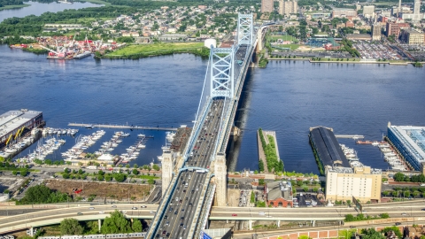 AXP079_000_0012F - Aerial stock photo of The Benjamin Franklin Bridge over the Delaware River between Philadelphia, Pennsylvania and Camden, New Jersey