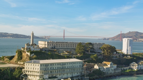 DCSF05_029.0000240 - Aerial stock photo of Alcatraz with the Golden Gate Bridge in the far distance, San Francisco, California