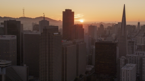 DCSF07_066.0000024 - Aerial stock photo of Skyscrapers with setting sun in background, Downtown San Francisco, California, sunset