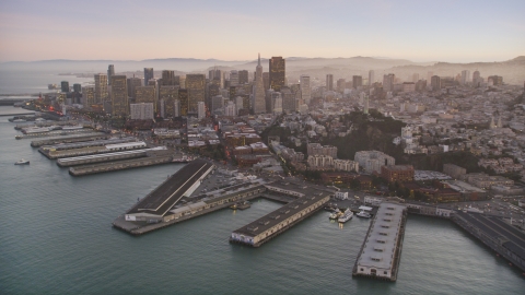 DCSF07_081.0000283 - Aerial stock photo of Piers by Coit Tower, and Downtown San Francisco skyscrapers, California, twilight