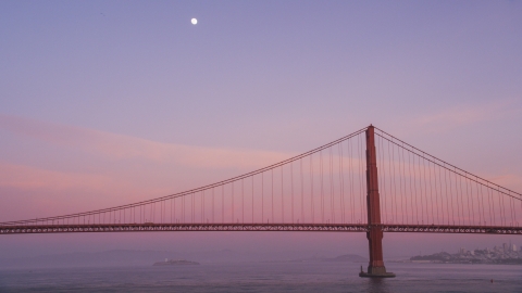 DCSF10_030.0000481 - Aerial stock photo of The moon above the Golden Gate Bridge at twilight in San Francisco, California