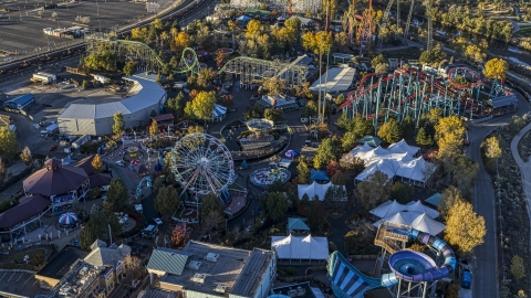 DXP001_000118 - Aerial stock photo of Theme park rides, Ferris wheel and roller coasters at Elitch Gardens at sunrise, Downtown Denver, Colorado