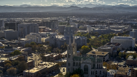 DXP001_000175 - Aerial stock photo of The Colorado State Capitol building behind a cathedral, mountains in background, Downtown Denver, Colorado