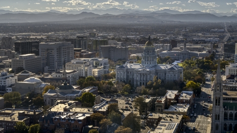 DXP001_000176 - Aerial stock photo of The Colorado State Capitol and nearby buildings, mountains in background, Downtown Denver, Colorado