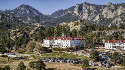 DXP001_000211 - Aerial stock photo of The historic Stanley Hotel, and mountains in the background in Estes Park, Colorado