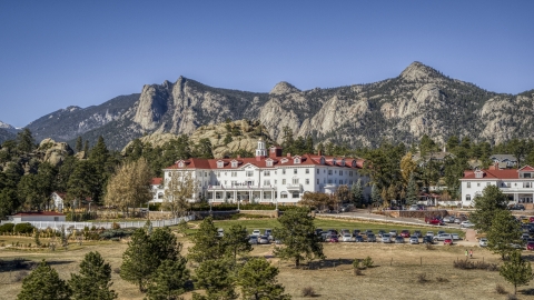 DXP001_000213 - Aerial stock photo of The famous Stanley Hotel, with mountains behind it in Estes Park, Colorado