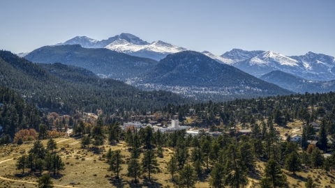 DXP001_000216 - Aerial stock photo of A small town with snowy mountains visible in the background in Estes Park, Colorado
