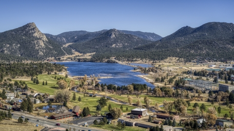 DXP001_000220 - Aerial stock photo of Golf course next to Lake Estes with mountains in the background in Estes Park, Colorado