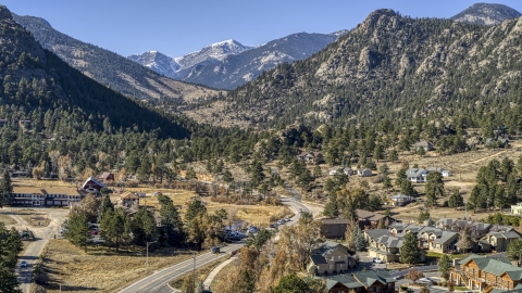 DXP001_000227 - Aerial stock photo of Rural homes by a road near rugged mountains, Estes Park, Colorado