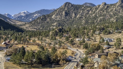 DXP001_000228 - Aerial stock photo of Rural homes beside a road near rugged mountains, Estes Park, Colorado