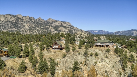 DXP001_000229 - Aerial stock photo of Rural hillside homes near rugged mountains, Estes Park, Colorado