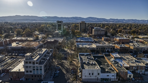 DXP001_000233 - Aerial stock photo of Taller office buildings and shops, mountains in the background in Fort Collins, Colorado