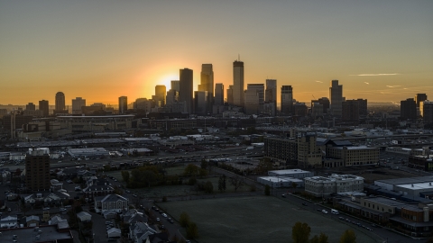 DXP001_000257 - Aerial stock photo of The sun behind tall skyscrapers in the city's skyline at sunrise in Downtown Minneapolis, Minnesota