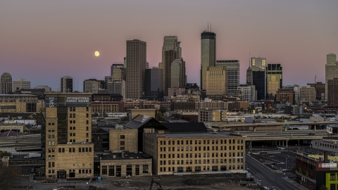 DXP001_000330 - Aerial stock photo of The moon in the sky near the city's skyline at twilight, marketplace building in the foreground, Downtown Minneapolis, Minnesota