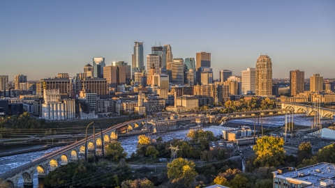 DXP001_000354 - Aerial stock photo of The downtown skyline seen from the Stone Arch Bridge spanning the river at sunrise, Downtown Minneapolis, Minnesota