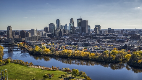 DXP001_000399 - Aerial stock photo of City skyline seen from the Mississippi River with fall trees, Downtown Minneapolis, Minnesota