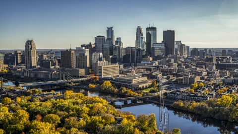DXP001_000411 - Aerial stock photo of Bridges spanning the river near autumn trees, and the skyline in the background, Downtown Minneapolis, Minnesota