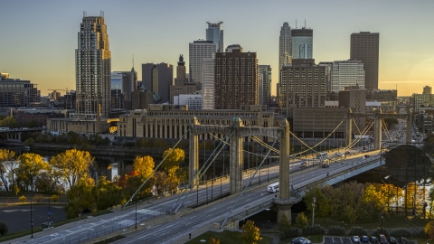 DXP001_000416 - Aerial stock photo of Hennepin Avenue Bridge spanning the river at sunset, skyline in the background, Downtown Minneapolis, Minnesota