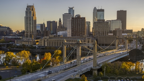 DXP001_000417 - Aerial stock photo of Traffic crossing the Hennepin Avenue Bridge spanning the river at sunset, skyline in the background, Downtown Minneapolis, Minnesota