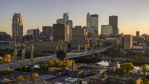 DXP001_000420 - Aerial stock photo of Hennepin Avenue Bridge spanning the river at sunset, with the skyline in the background, Downtown Minneapolis, Minnesota