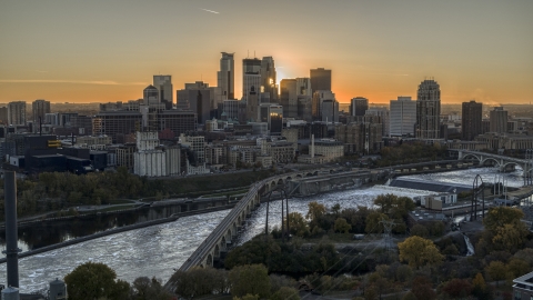 DXP001_000426 - Aerial stock photo of The city skyline, seen from a bridge over the Mississippi River at sunset, Downtown Minneapolis, Minnesota