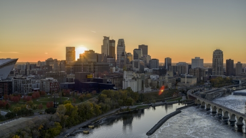 DXP001_000428 - Aerial stock photo of The city skyline on the other side of the river at sunset, seen from near a bridge, Downtown Minneapolis, Minnesota