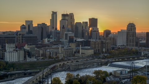 DXP001_000430 - Aerial stock photo of The city skyline on the other side of the bridge and river at sunset, Downtown Minneapolis, Minnesota