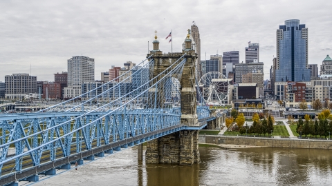 DXP001_000469 - Aerial stock photo of The Roebling Bridge spanning the Ohio River with the city skyline in the background, Downtown Cincinnati, Ohio
