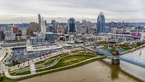 DXP001_000483 - Aerial stock photo of The city's skyline behind a riverfront park by the Ohio River in Downtown Cincinnati, Ohio