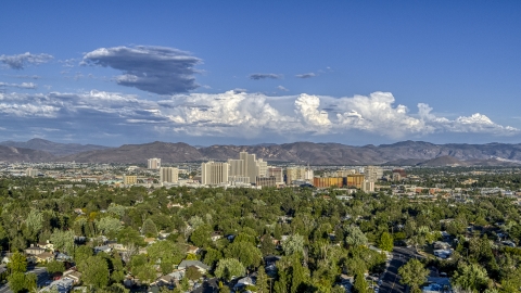 DXP001_005_0004 - Aerial stock photo of The city skyline seen from tree-lined neighborhoods in Reno, Nevada
