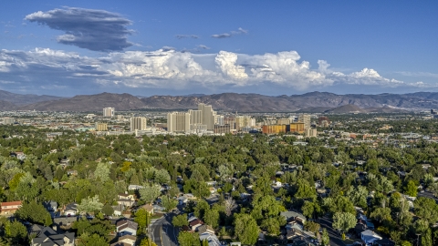 DXP001_005_0005 - Aerial stock photo of City skyline seen from tree-lined neighborhoods in Reno, Nevada