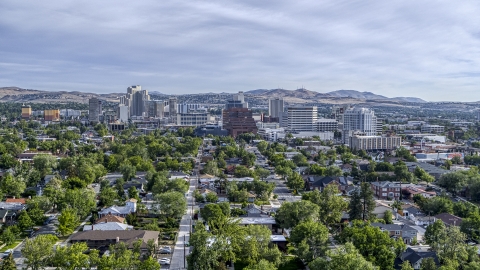 DXP001_006_0014 - Aerial stock photo of A wide view of high-rise casino resorts and office buildings seen from a neighborhood in Reno, Nevada