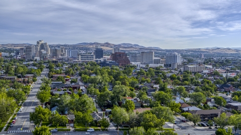 DXP001_006_0015 - Aerial stock photo of Casino resorts and office buildings seen from neighborhood with trees in Reno, Nevada