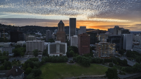 DXP001_014_0007 - Aerial stock photo of Skyscrapers behind hotel and office building at sunset in Downtown Portland, Oregon