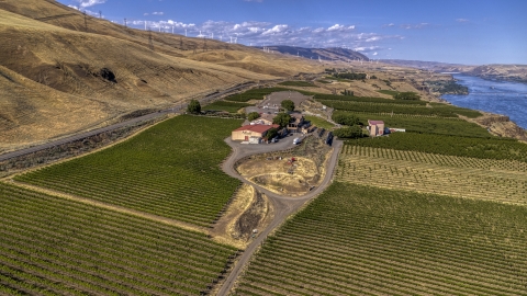 DXP001_018_0005 - Aerial stock photo of The Maryhill Winery and vineyards with the river in the background in Goldendale, Washington