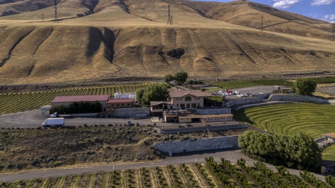 DXP001_018_0015 - Aerial stock photo of The Maryhill Winery near brown hills in Goldendale, Washington