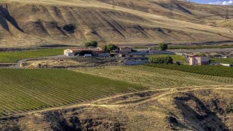 DXP001_018_0030 - Aerial stock photo of The Maryhill Winery seen from nearby cliffs in Goldendale, Washington