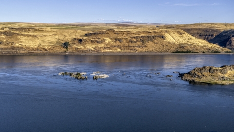 DXP001_019_0014 - Aerial stock photo of Small rock formations in the Columbia River in Goldendale, Washington