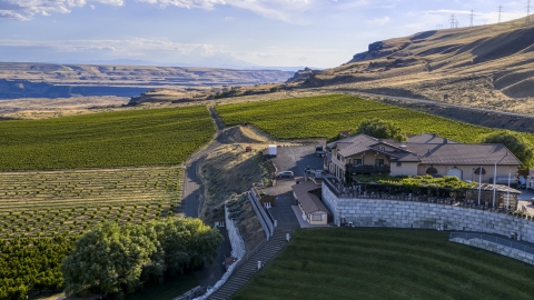 DXP001_019_0019 - Aerial stock photo of The Maryhill Winery and surrounding vineyard seen from the amphitheater in Goldendale, Washington